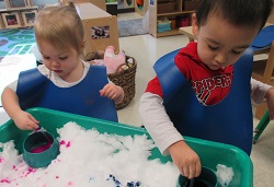 toddlers painting with snow