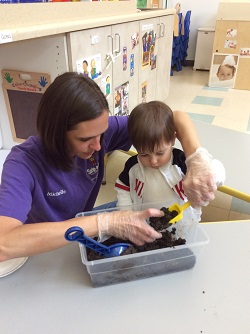 teacher gardening with child